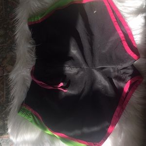 Green and Pink running shorts.